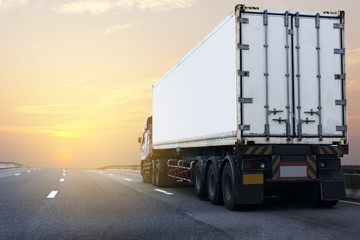 Truck on highway road with white container, transportation concept.,import,export logistic industrial Transporting Land transport on the asphalt expressway with sunrise sky