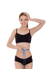 Obraz premium woman measuring waist with blue measuring tape.