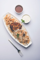 Authentic Fish Biryani served in a white plate over white background, selective focus