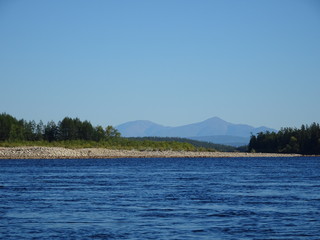 Landscape: calm river and mountains in the background
