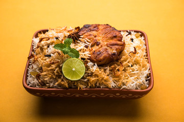 Authentic Fish Biryani served in a white plate over white background, selective focus