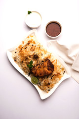 Authentic Fish Biryani served in a white plate over white background, selective focus