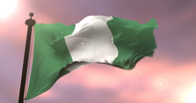 Flag of Nigeria waving at wind in slow at sunset, loop