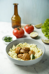 Spice meatballs with vegetable sauce and couscous