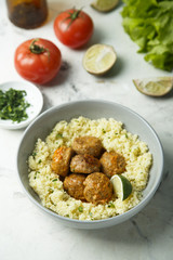 Spice meatballs with vegetable sauce and couscous