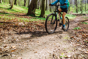 Fototapeta na wymiar young woman ride bicycle in forest by trail