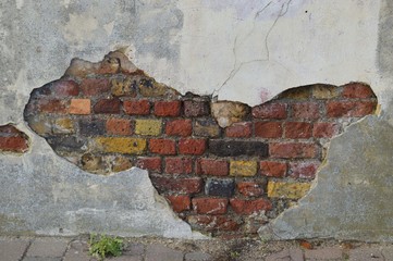 Wall braking away to reveal brickwork