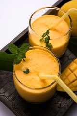 Mango Lassi, Indian popular summer drink in a terracotta glass, selective focus