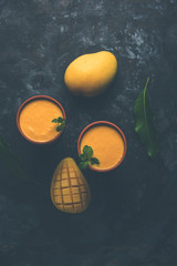 Mango Lassi, Indian popular summer drink in a terracotta glass, selective focus