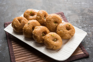 Balushahi sweet food served in a white or golden plate over moody background
