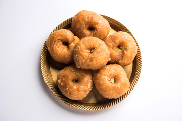 Balushahi sweet food served in a white or golden plate over moody background