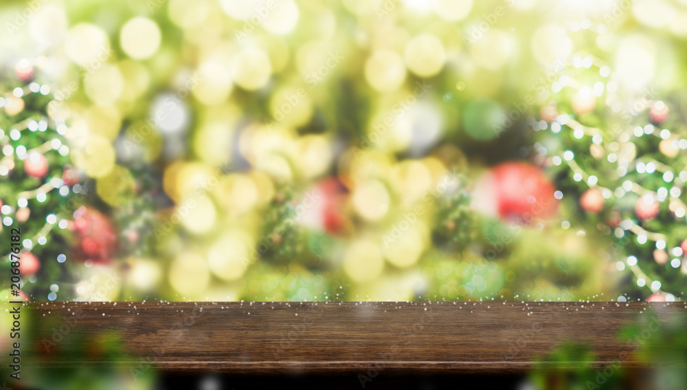 Leinwandbilder empty dark brown wood table top with abstract blur christmas tree red decor ball and snow fall backg