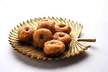 Balushahi sweet food served in a white or golden plate over moody background