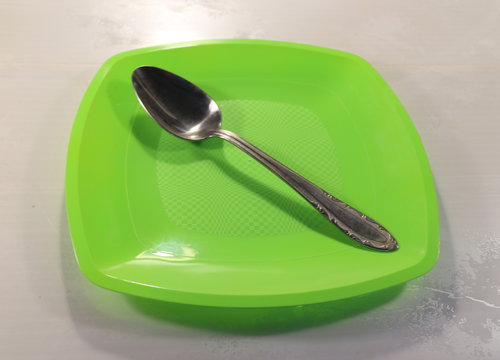 a tablespoon on a green plate