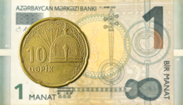 10 azerbaijani qepik coin against 1 azerbaijani manat bank note