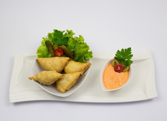 Traditional Arabic dish, sausages with decoration of green salads and cucumbers, with sauce of sauce