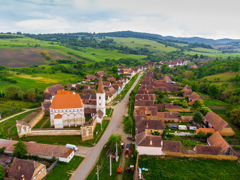Bike route in Cloasterf Saxon Village and Fortified Church in Transylvania, Romania. Cyclist on the road. Bike ride recreation in Romania Bicycle tourists in old village. Group of friends riding bikes