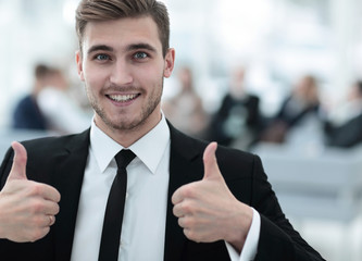 successful businessman showing thumbs up.