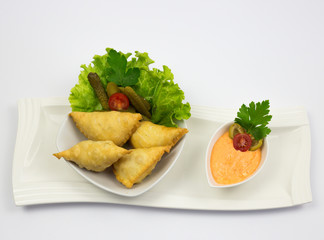 Traditional Arabic dish, sausages with decoration of green salads and cucumbers, with sauce of sauce