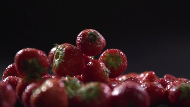 Close-up of a strawberry falling on each other.
