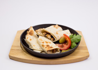 Arabian dough, wrapped chicken with decoration of tomato and lettuce, traditional dish, restaurant, specialties, kitchen, chef, served