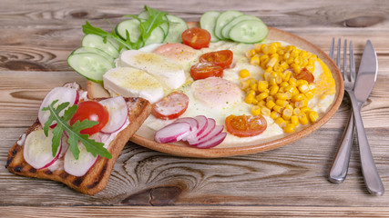 Breakfast. Fried eggs with cherry tomatoes, mozzarella cheese, fresh vegetables and homemade sandwiches. Healthy breakfast concept. Banner