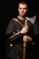 Male medieval warrior in armour and chain mail, viking with batt