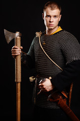 Male medieval warrior in armour and chain mail, viking with batt
