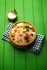 Dabeli is an Indian snack item served with Pomegranate Seeds and Cilantro in white ceramic plate. It's a popular Navratri Festival food