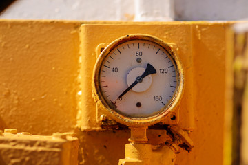 gauge pressure in the pipeline,a wall in the background