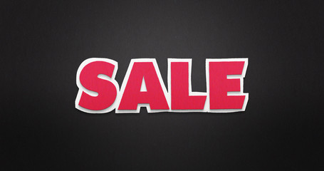 Sale. Pink word on black background with paper texture.