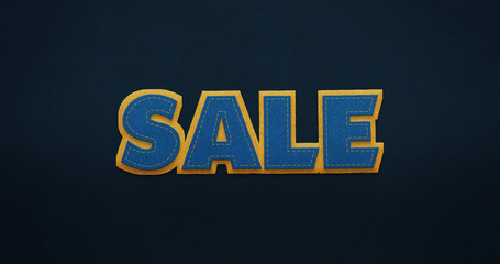 Sale. Blue word with yellow contour on dark blue background with felt texture.