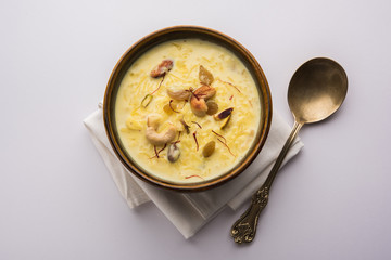 Rice pudding OR Kheer from India called also called Firnee. served in a bowl. Selective focus