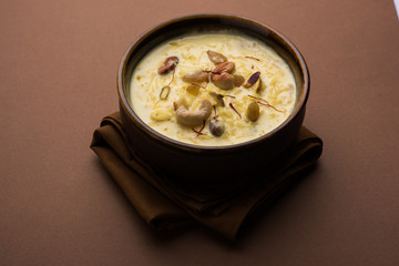 Rice pudding OR Kheer from India called also called Firnee. served in a bowl. Selective focus