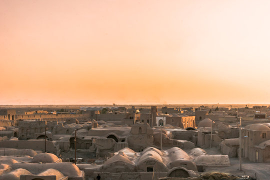 Sunset over ghost town of Ghoortan citadell by Varzaneh in Iran