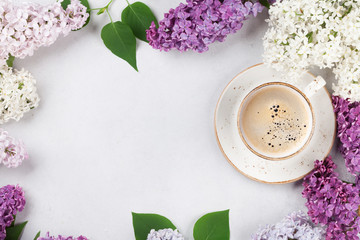 Fototapeta na wymiar Colorful lilac flowers and coffee cup