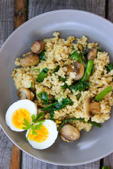 Warm bulgur salad with fried mushrooms, asparagus and spinach