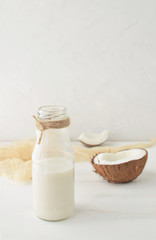 Obraz na płótnie Canvas Vegetarian coconut milk in glass bottle