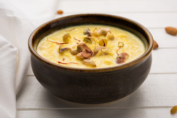Rice pudding OR Kheer from India called also called Firnee. served in a bowl. Selective focus