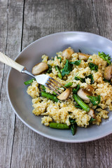 Warm bulgur salad with fried mushrooms, asparagus and spinach