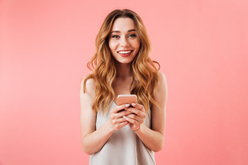 Portrait of a smiling young woman holding mobile phone