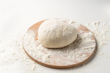 Fototapeta na wymiar Fresh raw dough on wooden board isolated on white background