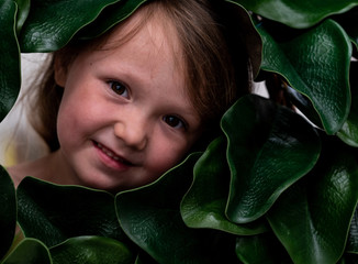 Young Innocent Girl peeks through Green Leaf Wreath
