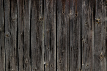 Obraz premium Vertical old natural weathered wooden fence, background texture.