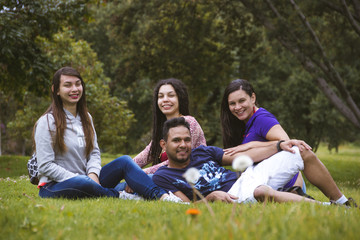 Fototapeta premium four friends lying on the grass laughing