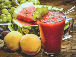 Watermelon smoothies, peaches, grapes, plums. From the side