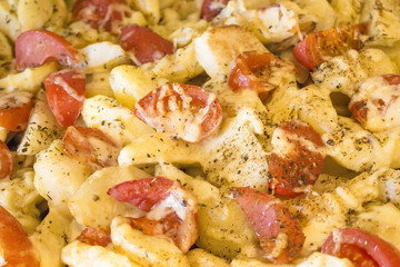 fried potatoes with red tomatoes on a plate