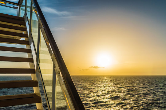 Stairway of cruise ship with beautiful sunset and ocean view.