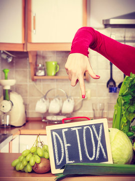 Woman having green diet vegetables, detox sign