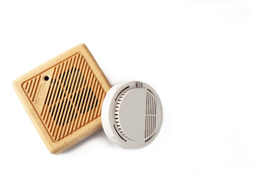Old domestic smoke detector alarms on white background